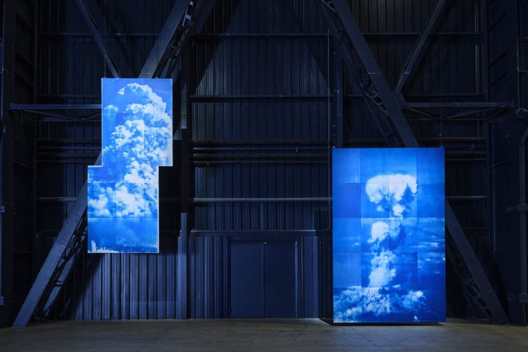 Yukinori Yanagi. Atomic Clouds over Ground Zero (Left) From the Ground, Hiroshima, 8:30 am, August 6, 1945 (Right) From the Sky, Hiroshima, 8:30 am, August 6, 1945 Cyanotype exposed by the sun of 8:30 am, August 6, 2024, 2024. Installation view, Pirelli HangarBicocca, Milan, 2025 ©YANAGI STUDIO Courtesy the artist and Pirelli HangarBicocca, Milan. Photo Agostino Osio